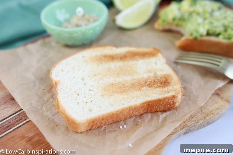 low carb bread on a wood cutting board with limes and seasonings in the background