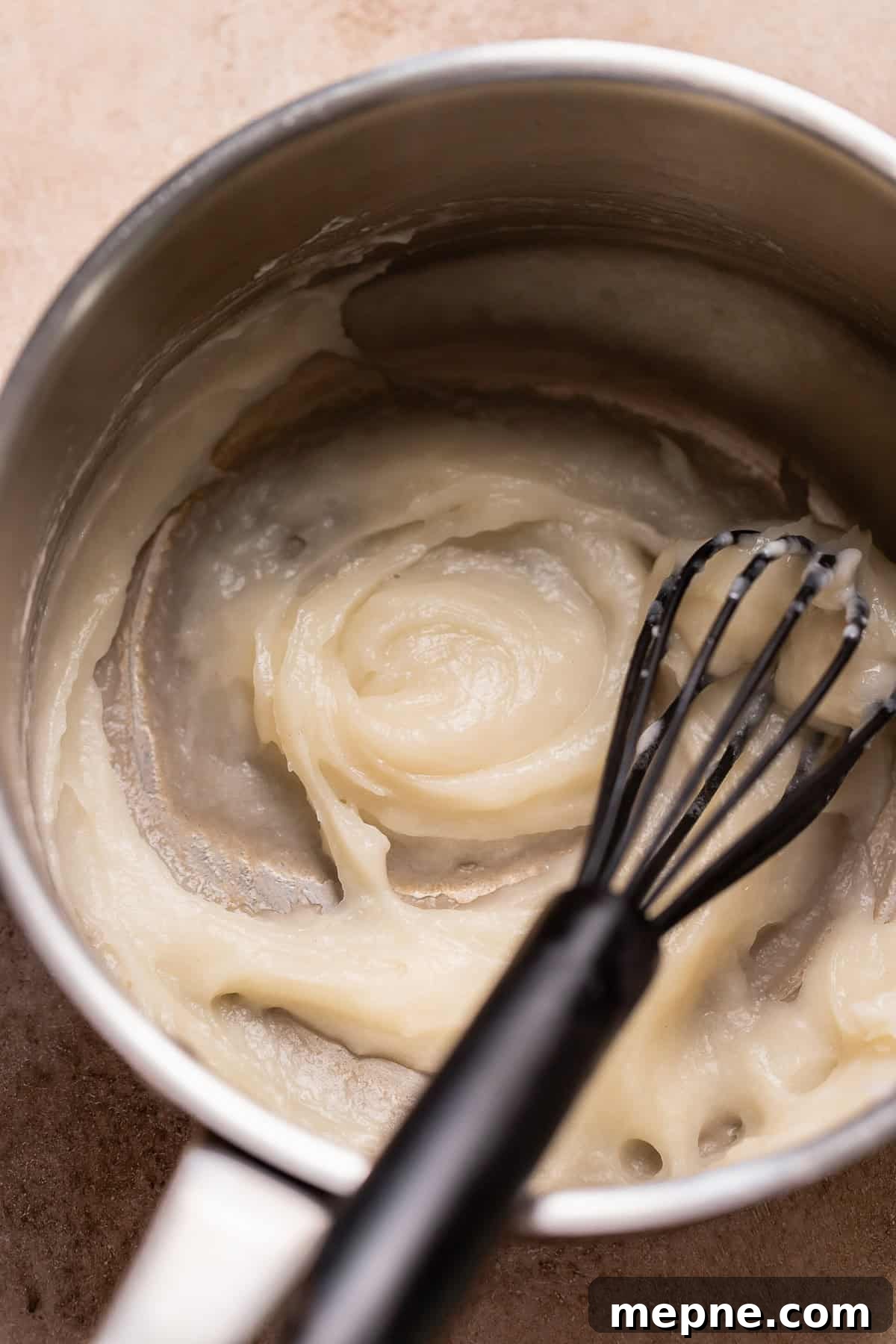 Tropical Pina Colada Cinnamon Rolls with Coconut Rum Icing 3 Cooked tangzhong in a pot with a whisk.