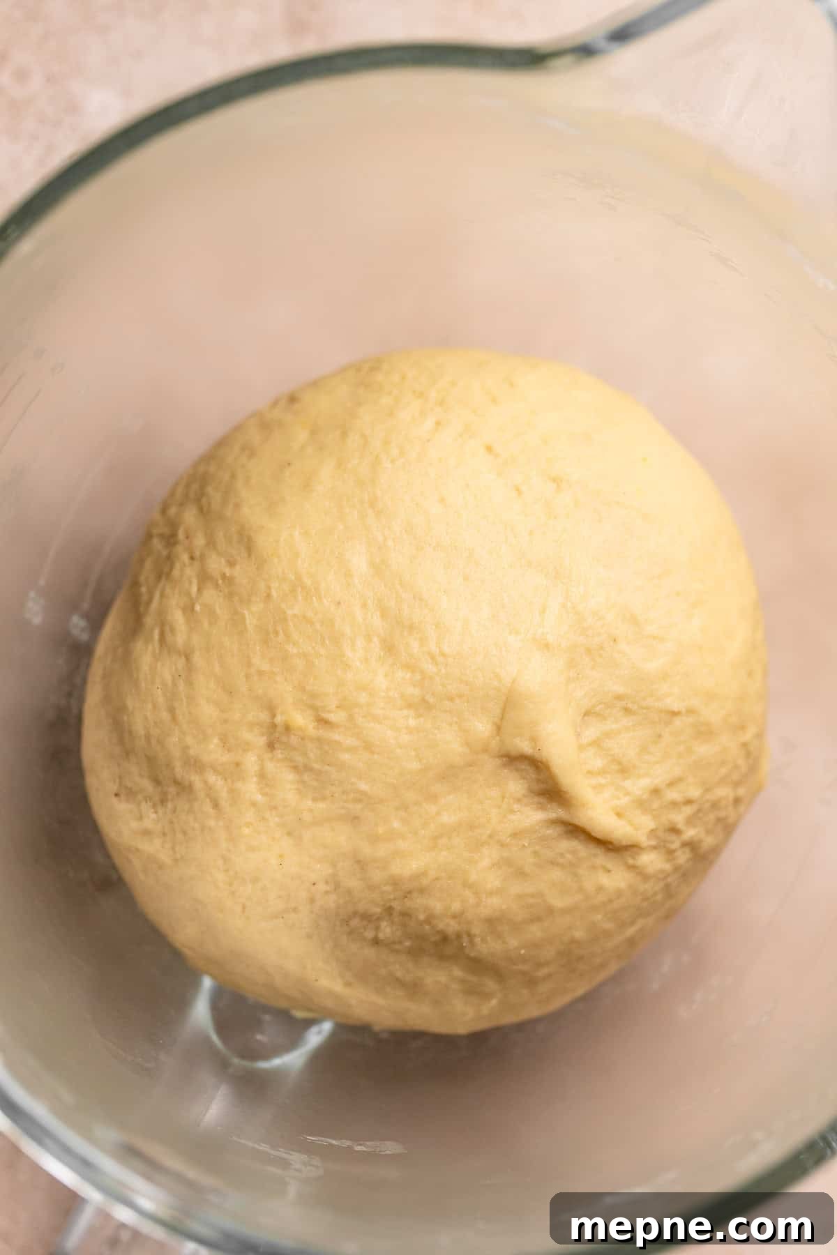 Tropical Pina Colada Cinnamon Rolls with Coconut Rum Icing 6 A smooth round dough ball in a mixer bowl.