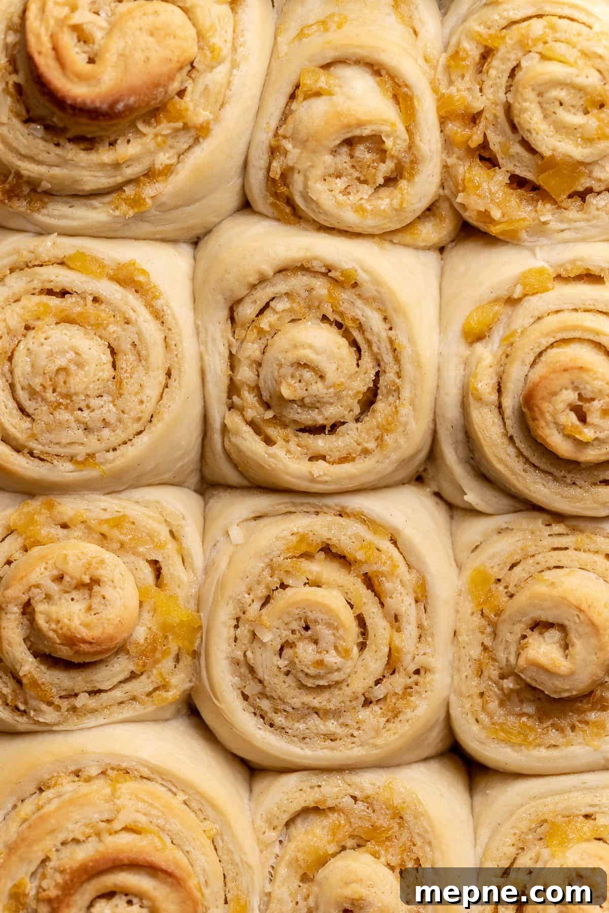 Tropical Pina Colada Cinnamon Rolls with Coconut Rum Icing 10 The baked pina colada rolls in a baking pan.
