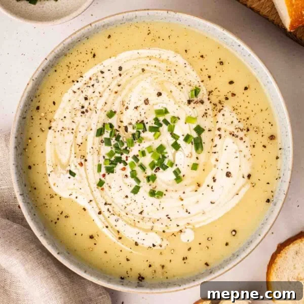 Creamy Broccoli and Stilton Soup Recipe 11 A bow of leek and potato soup with chives and black pepper on top, ready to eat.
