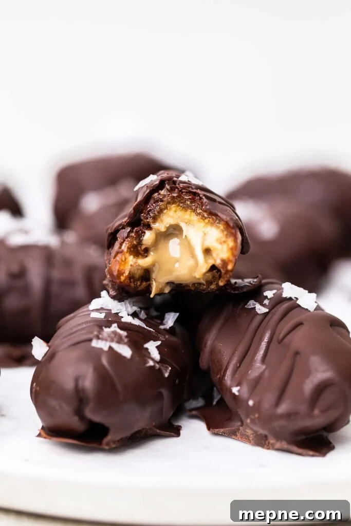 Chocolate-Stuffed Medjool Dates with Nut Butter 11 A chocolate date cut in half to show the nut butter filling.