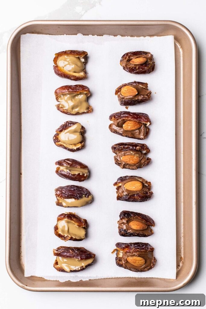 Chocolate-Stuffed Medjool Dates with Nut Butter 6 Dates shown filled with nut butter and almonds.