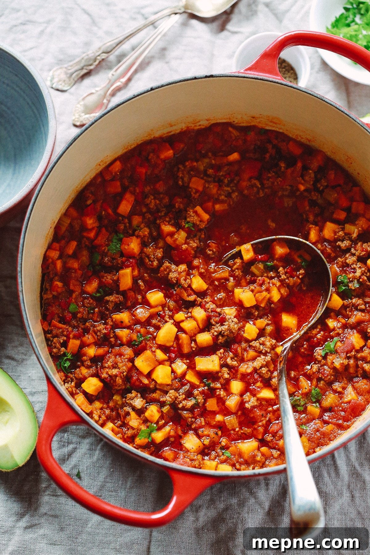 Keto Dinner Recipes: Low-Carb Ideas for Weeknights 17 Overhead view of butternut squash chili in a red lard bowl with a ladle inside.