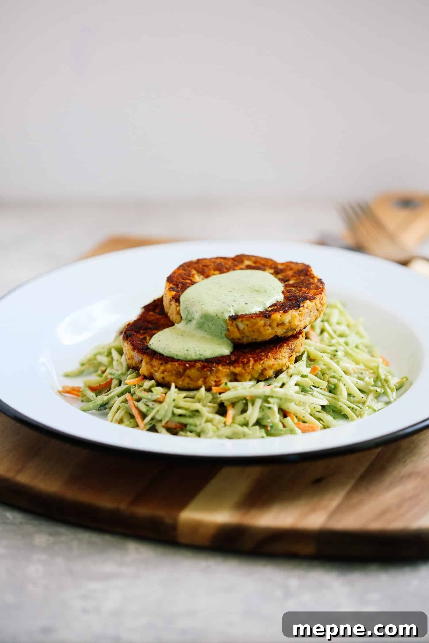 Keto Dinner Recipes: Low-Carb Ideas for Weeknights 24 Salmon patties with coleslaw salad on a white plate.