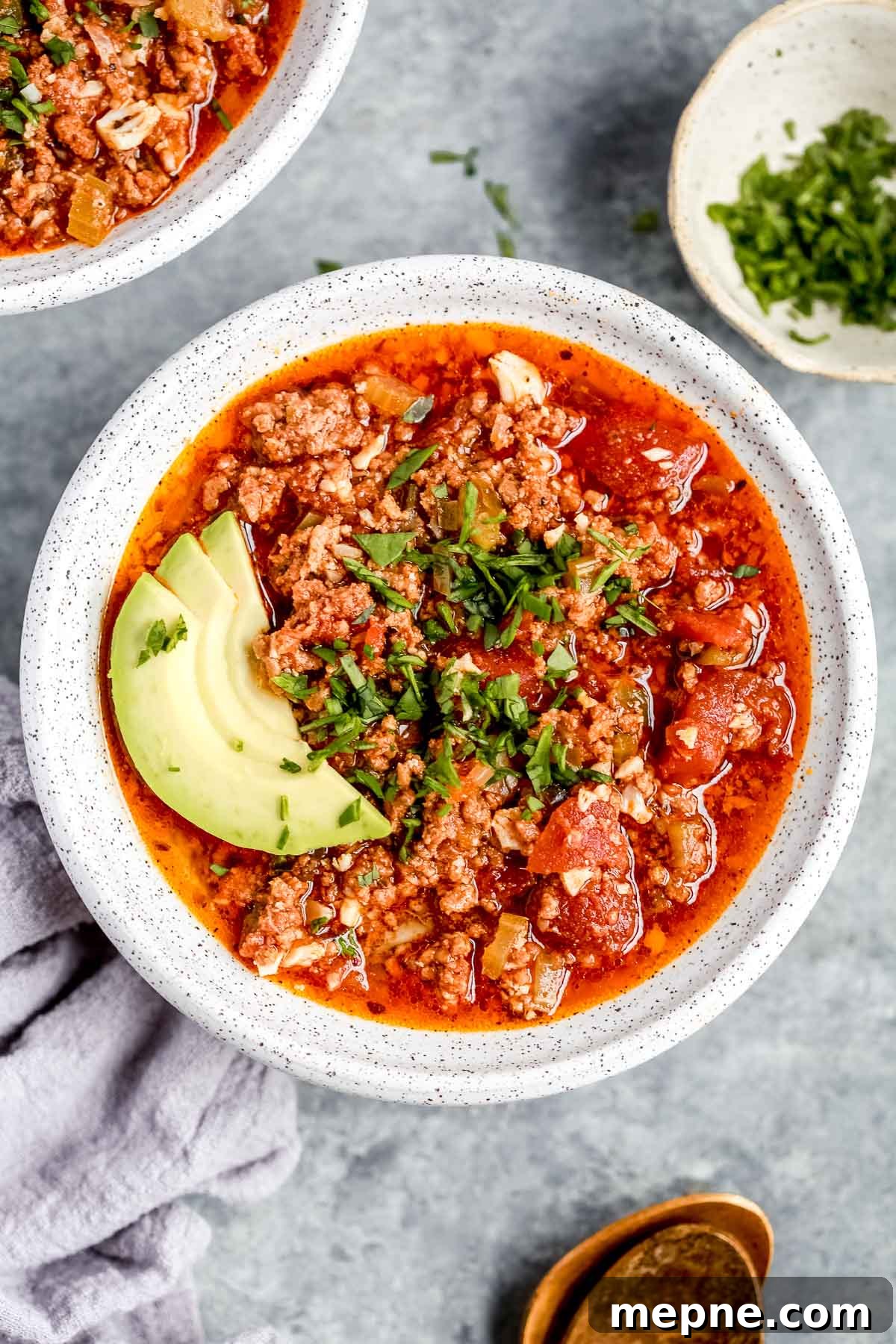 Keto Dinner Recipes: Low-Carb Ideas for Weeknights 4 overhead view of a full white bowl of keto chili with avocado slices on top