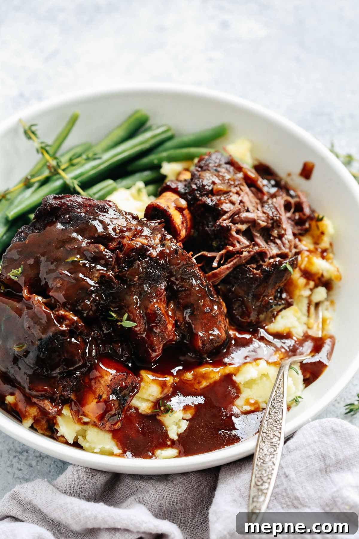 Keto Dinner Recipes: Low-Carb Ideas for Weeknights 5 A close up of short ribs with green beans and mashed potatoes in a white bowl
