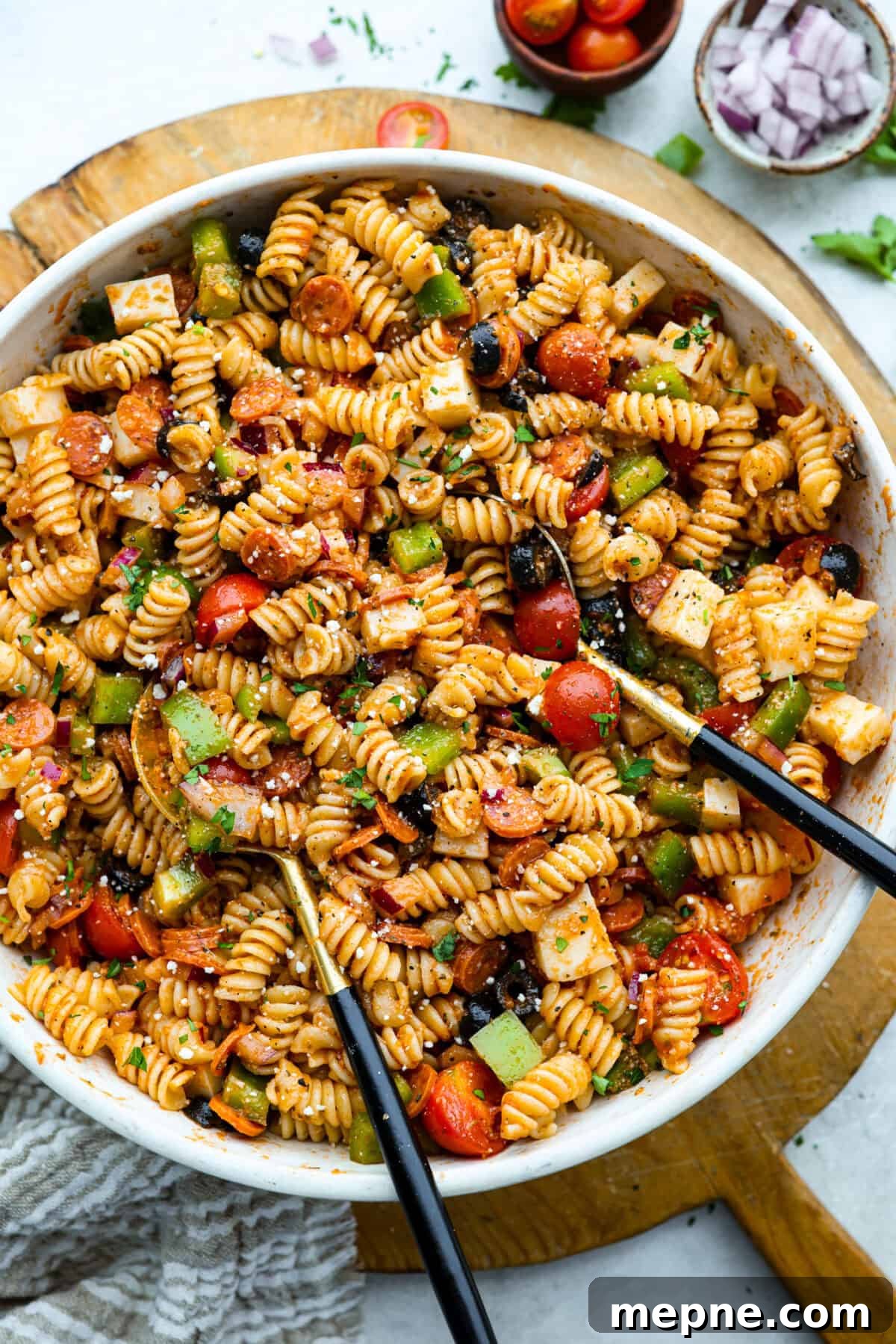 Large serving bowl of pizza pasta salad.