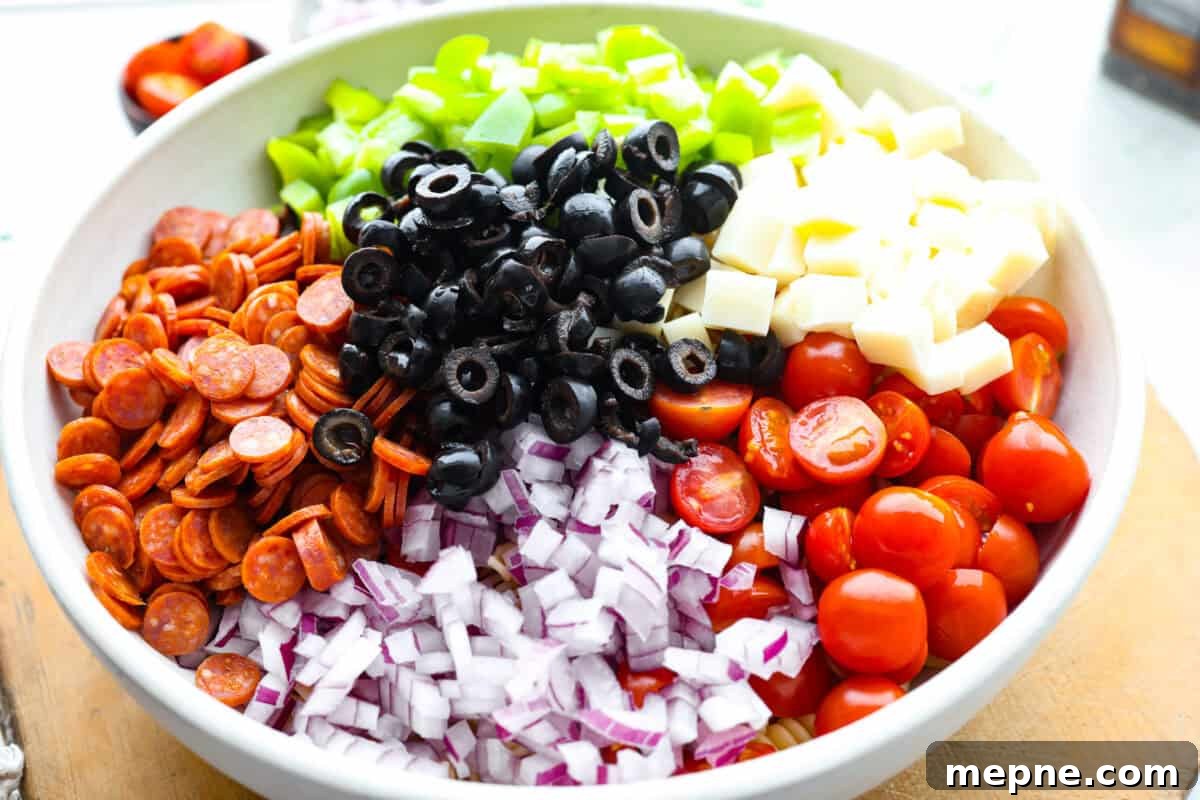 Chopped salad ingredients added to a bowl.