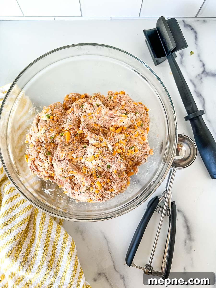 Turkey Sausage Balls Recipe 5 A clear bowl with uncooked turkey sausage meatball mixture.