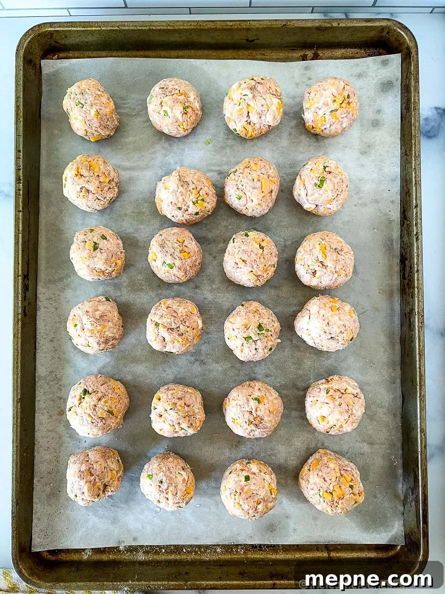 Turkey Sausage Balls Recipe 6 Meatball mixture rolled and arranged on a sheet pan, ready to bake in the oven