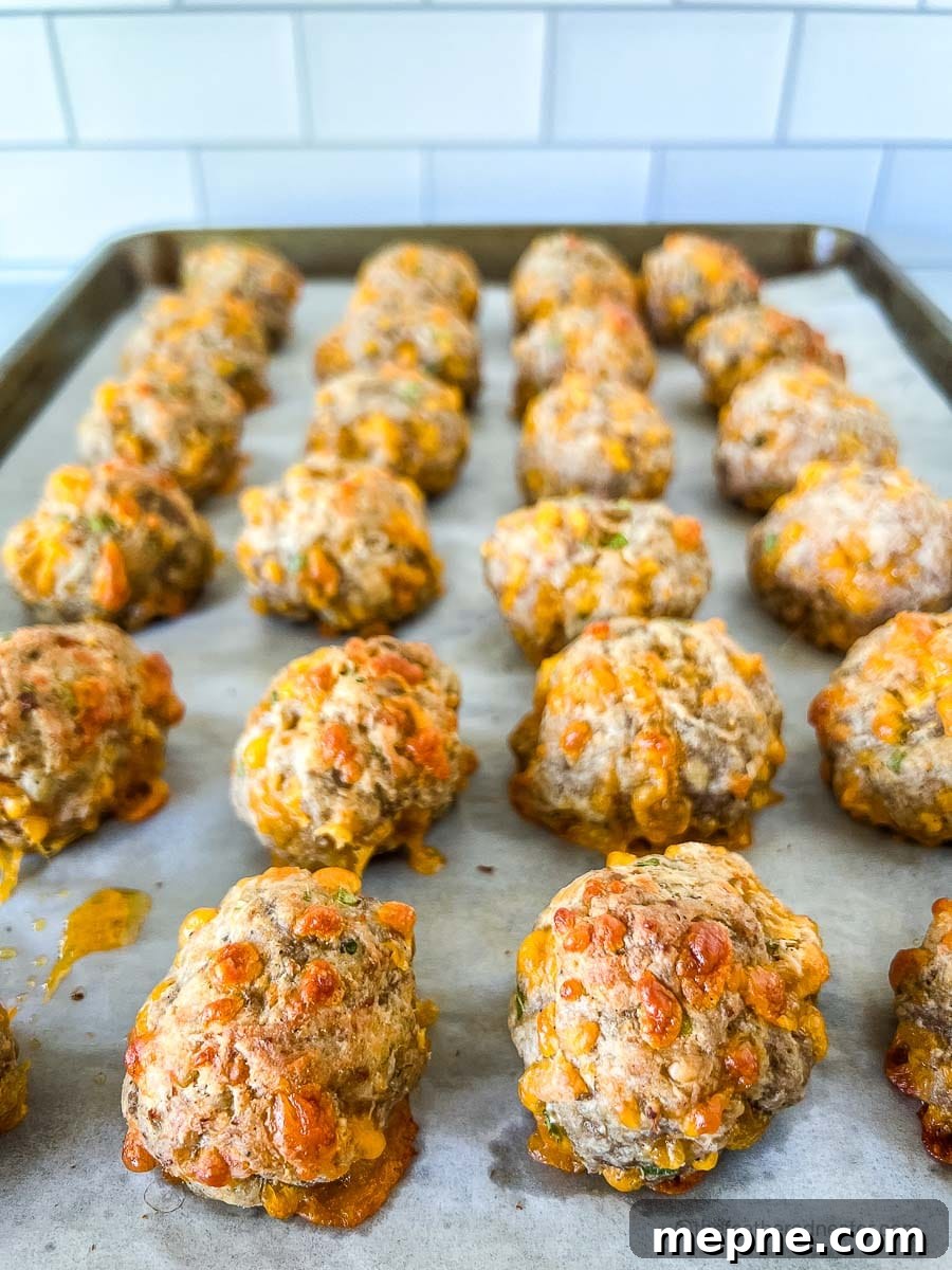 Turkey Sausage Balls Recipe 10 a closeup of baked ground turkey balls on a parchment lined baking sheet