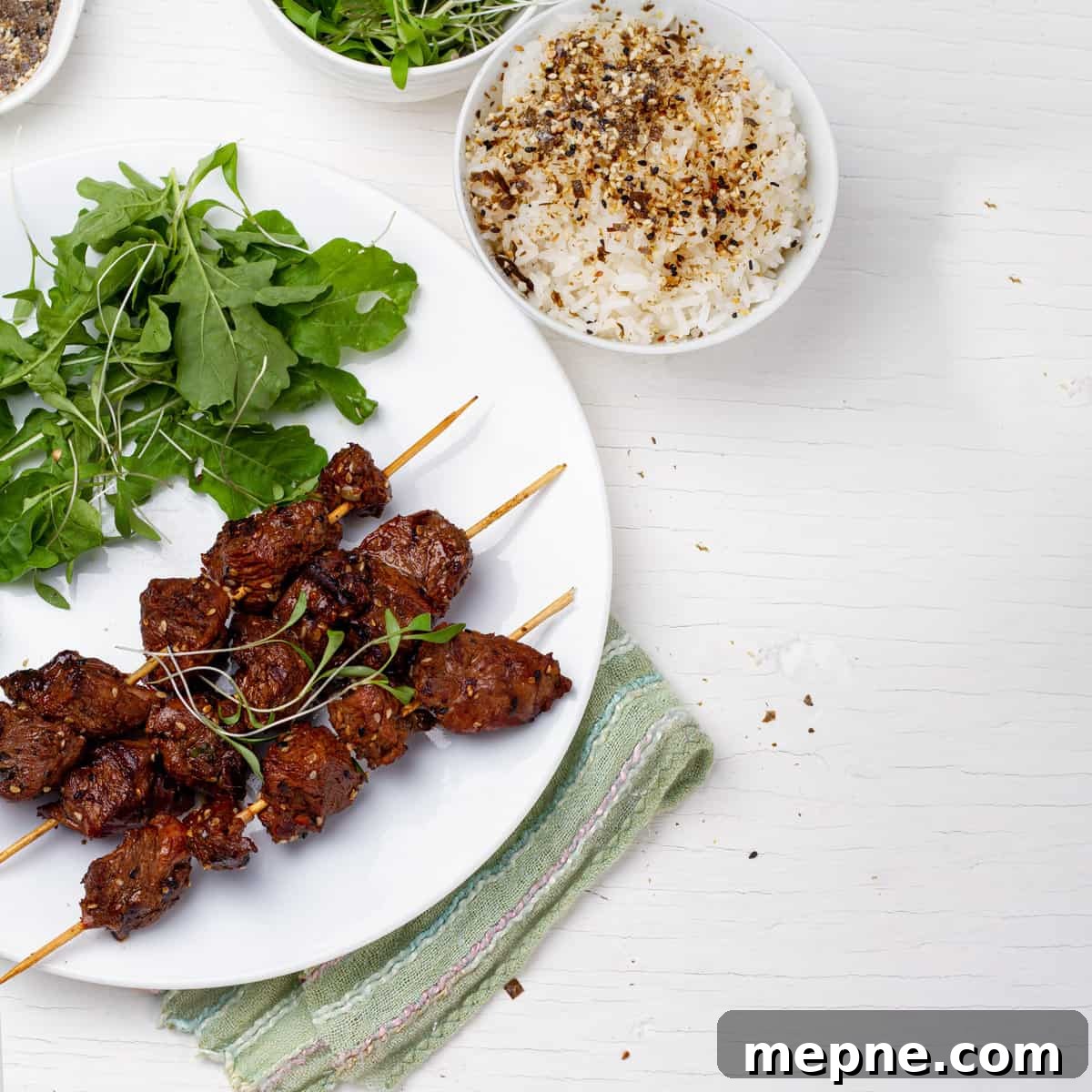 Green Tea-Marinated Beef Skewers 2 Green Tea Beef Kebabs plated with green salads