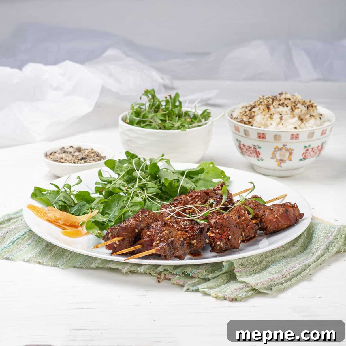 Green Tea-Marinated Beef Skewers 6 Green Tea Beef Kebabs plated with green salads