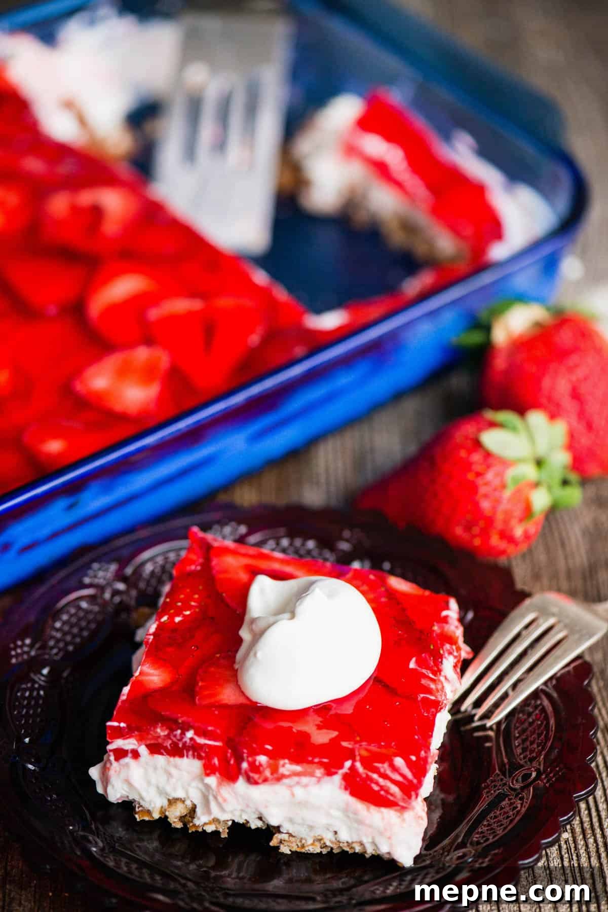 Strawberry Pretzel Dessert with real whipped cream, sliced strawberries, and a pretzel crust.