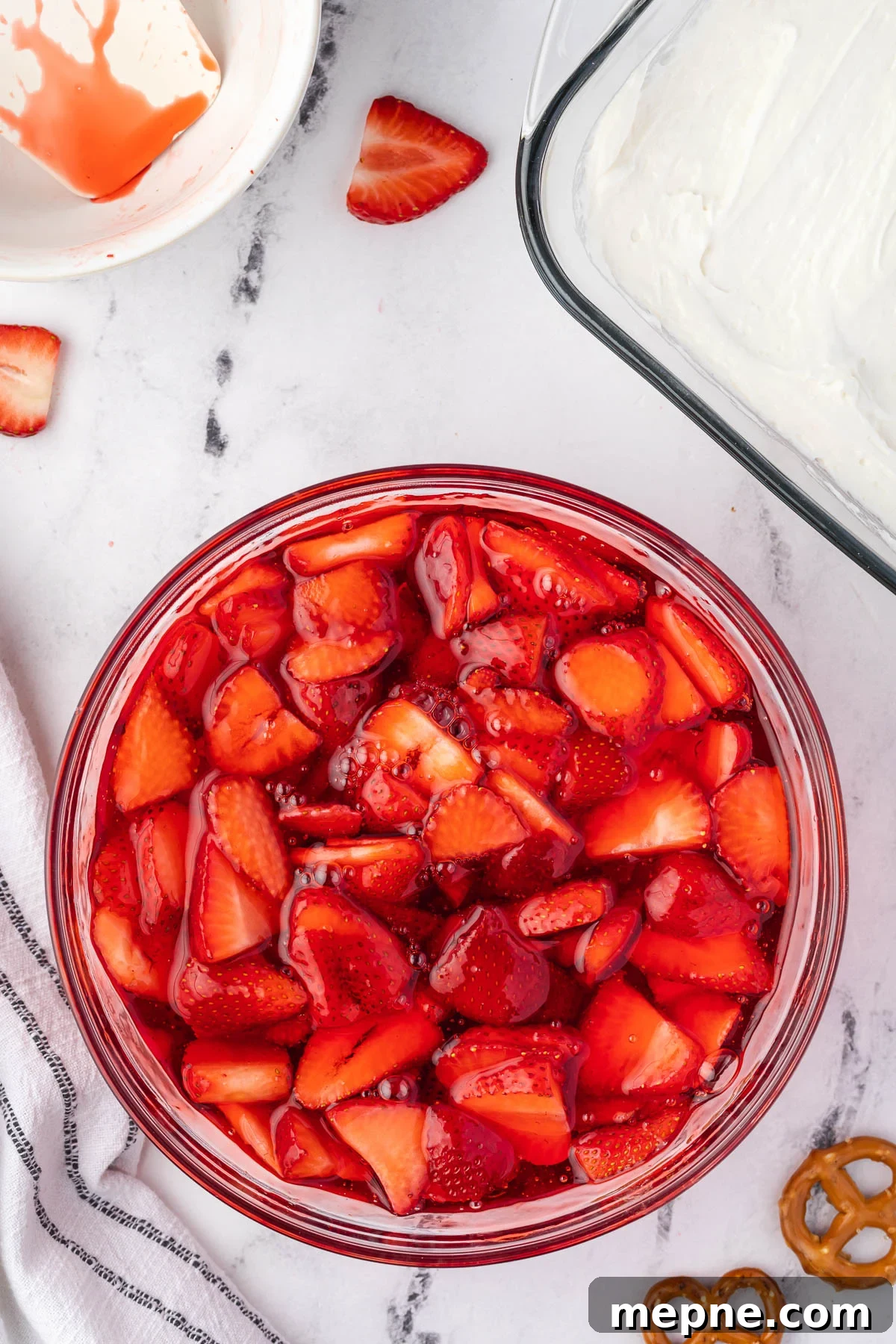 Sliced strawberries folded into strawberry gelatin.