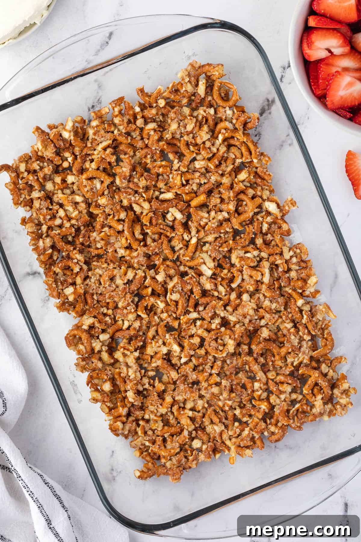 Spread pretzel crust in a greased baking dish.