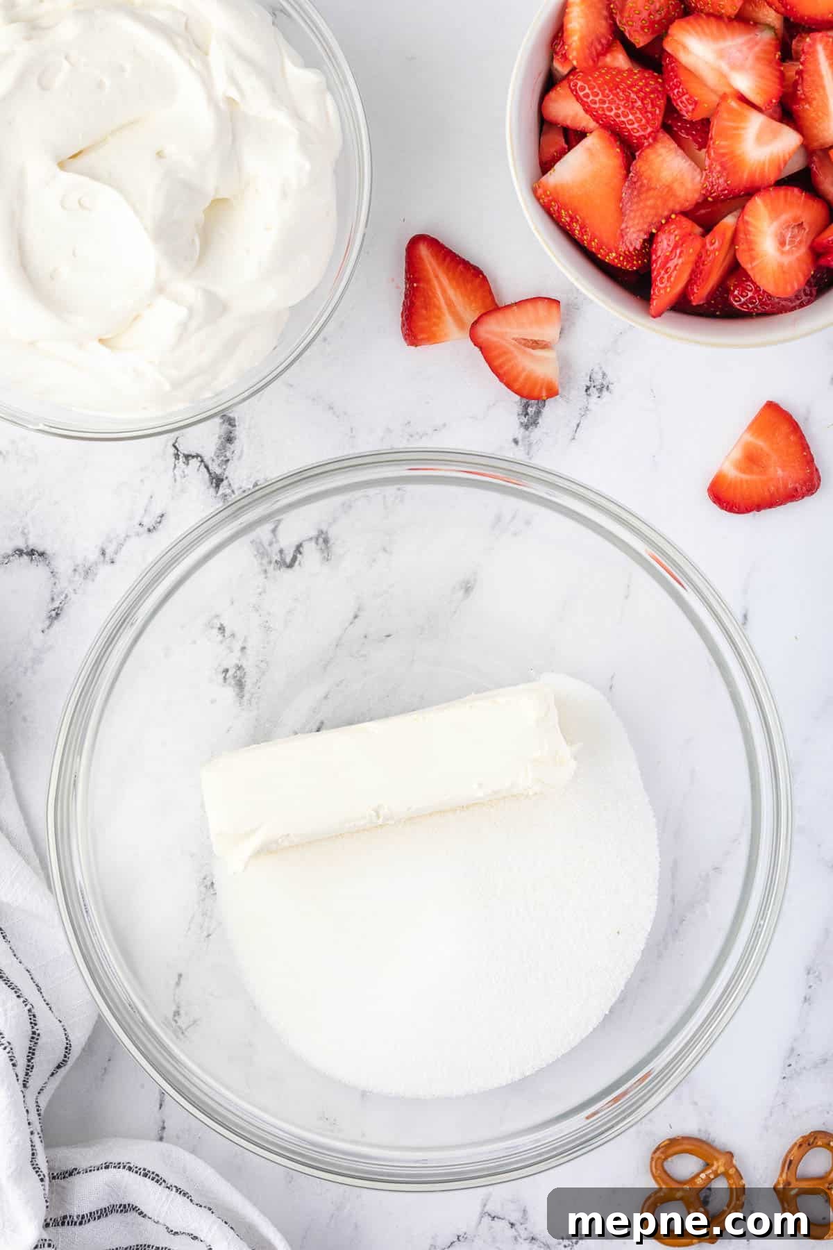 Cream cheese and sugar combined in a bowl.
