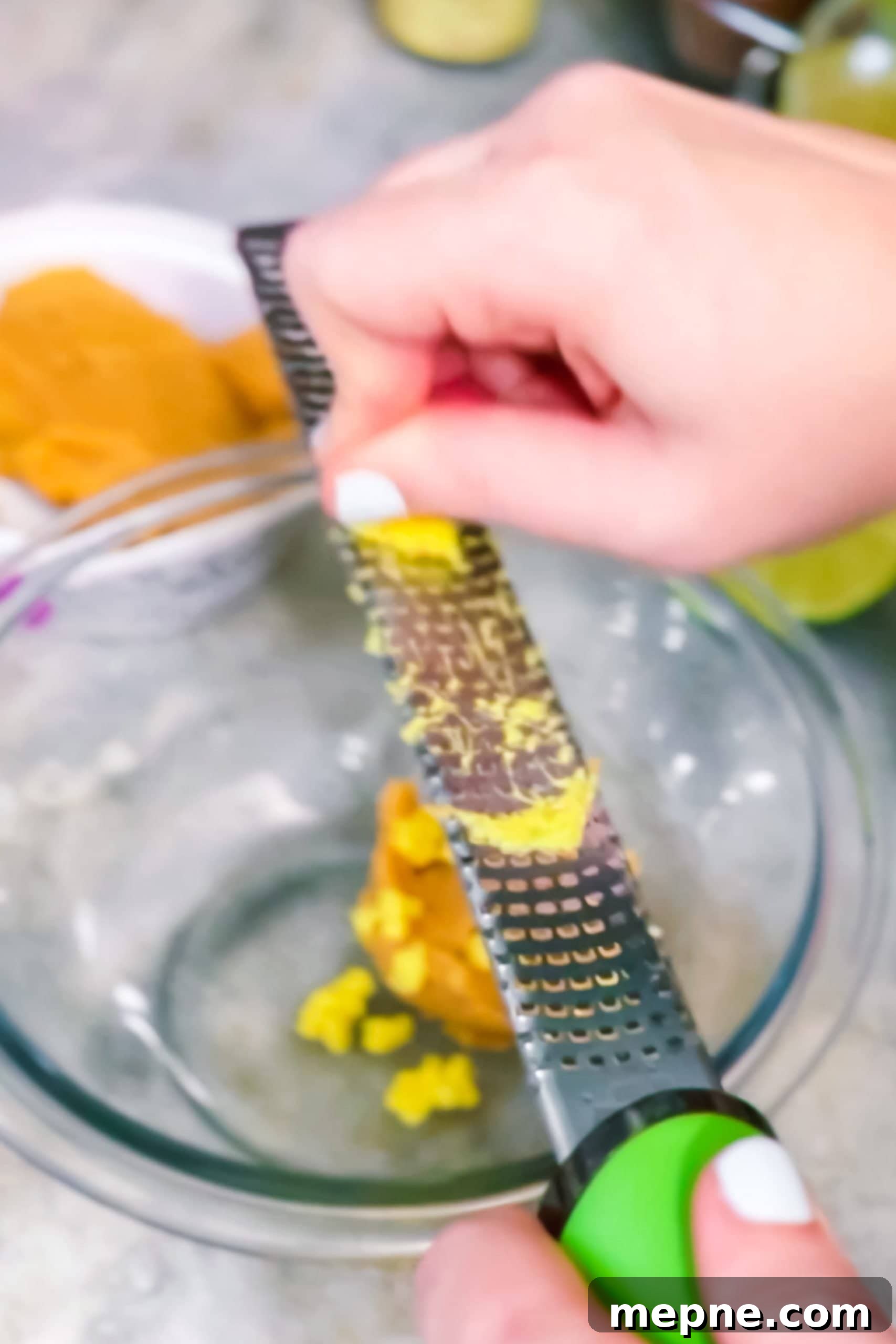 Grating ginger on a microplane.