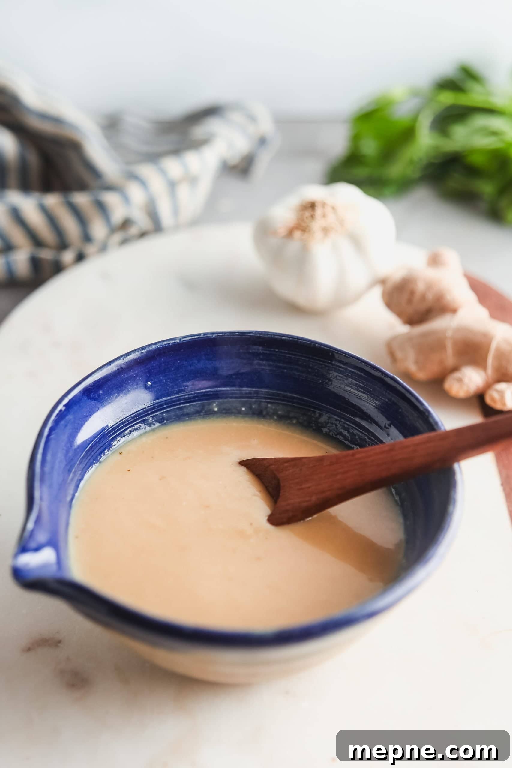 Miso sauce in a blue dish on a marble counter.
