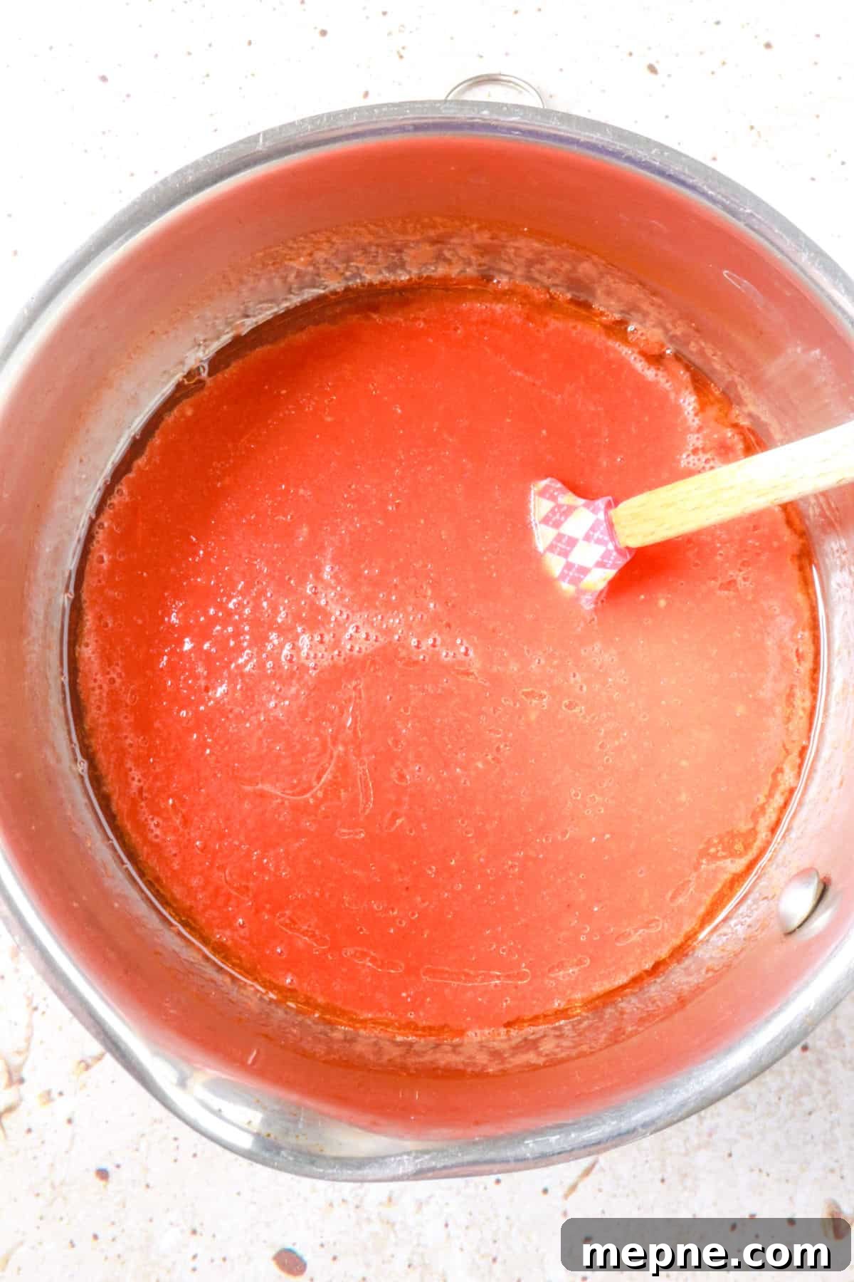 tomato sauce simmering in a saucepan