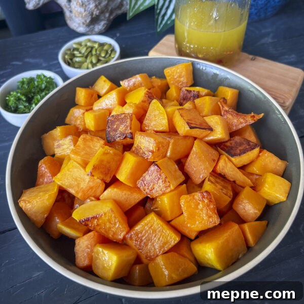 Roasted Butternut Squash Grain Bowl with Hot Honey Drizzle 4 roasted butternut squash cubes in bowl