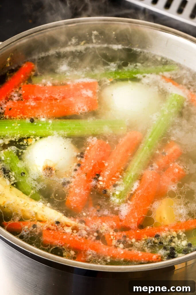 Romanian Chicken Soup (Ciorbă de pui) Recipe 8 foam removed and soup coming to a boil.