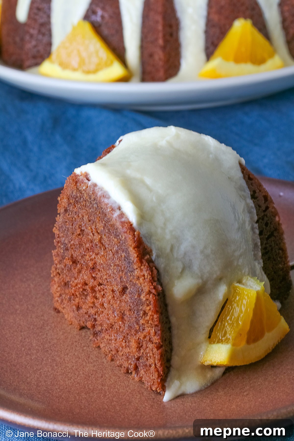 Gluten-Free Orange Chocolate Buttermilk Bundt Cake 5 Whole chocolate/orange bundt cake with cascading orange flavored glaze and fresh orange slices around the exterior.