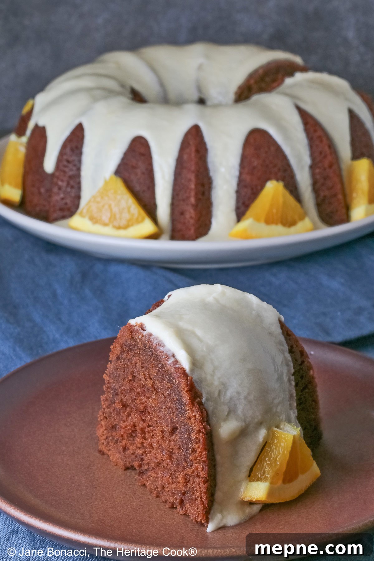 Gluten-Free Orange Chocolate Buttermilk Bundt Cake 6 Whole chocolate/orange bundt cake with cascading orange flavored glaze and fresh orange slices around the exterior.
