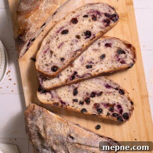 Slices of blueberry sourdough bread on a cutting board