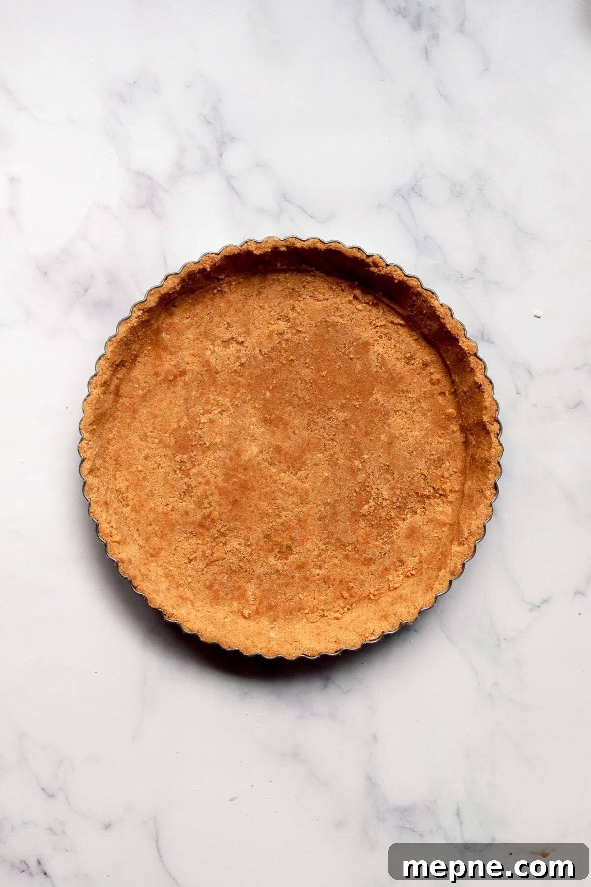Dark Chocolate Raspberry Tart Recipe 6 Par-baked graham cracker crust cooling in a tart pan.