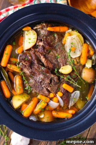 Tender red wine slow cooker pot roast with potatoes and carrots.