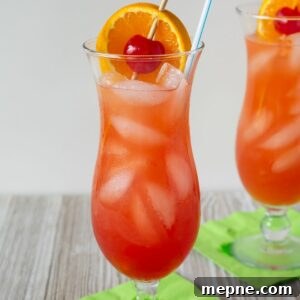 Classic Fruity Hurricane Cocktail Recipe 12 Classic Hurricane Cocktail served with orange slice and cherry garnish in a hurricane glass.