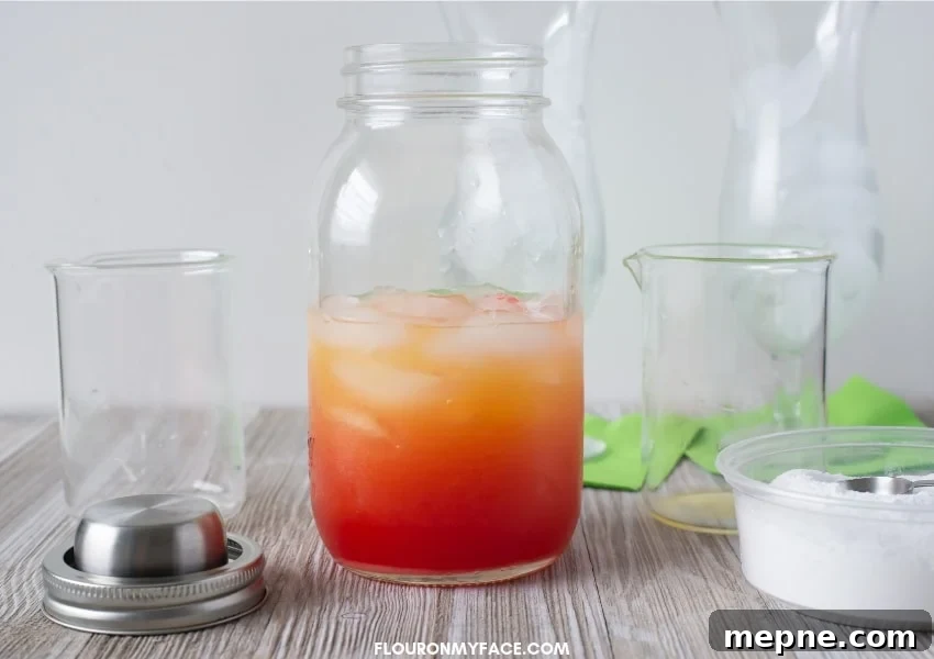 Classic Fruity Hurricane Cocktail Recipe 4 A photo of a Hurricane Cocktail ingredients in a clear mason jar cocktail shaker showing the layers of red and orange when the ingredients are combined before shaking.