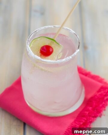 Coconut Rum Cobbler cocktail served in a highball glass with cherry and lime garnish.