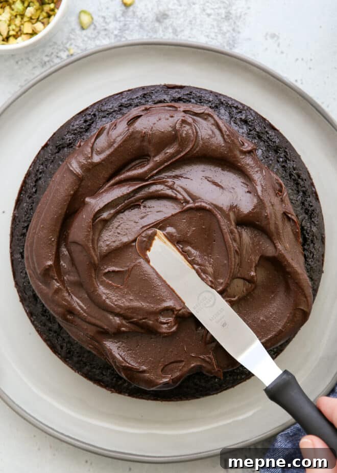 Moist Chocolate Olive Oil Cake Recipe 5 spreading ganache on top of chocolate olive oil cake