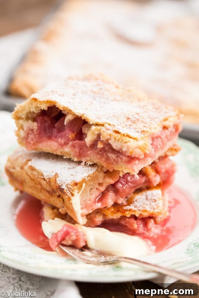 Rustic Rhubarb Slab Pie Recipe 2 close up of Rhubarb slab pie pieces stacked on a plate