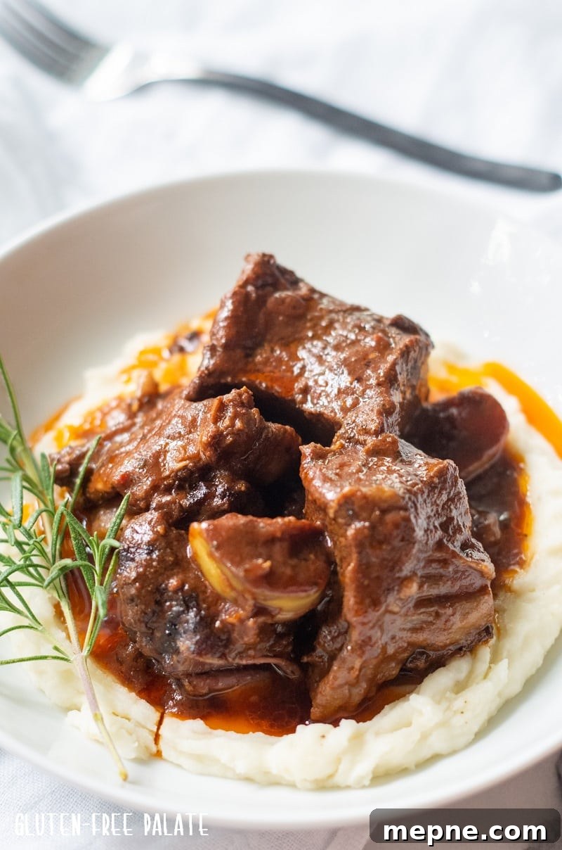 Tender Slow Cooker Beef Short Ribs Recipe 5 side view of beef short ribs over mashed potatoes