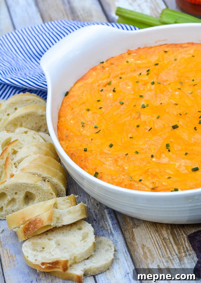 cheesy buffalo chicken dip in a white serving bowl