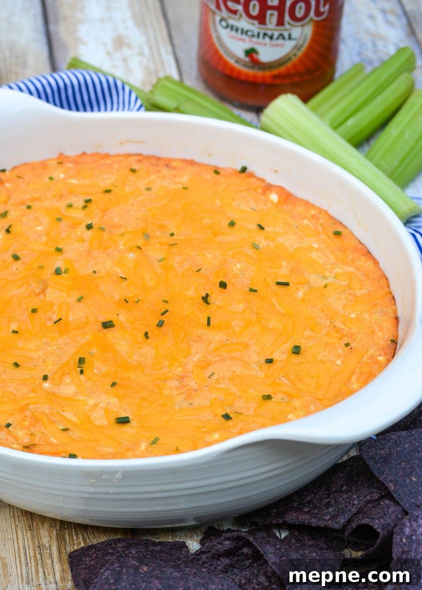 the best buffalo chicken dip in a white serving bowl