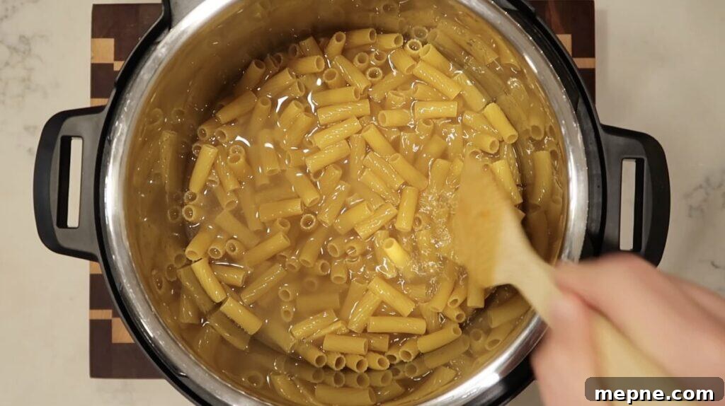 Instant Pot Meatballs with Marinara Pasta 5 Submerging pasta in broth