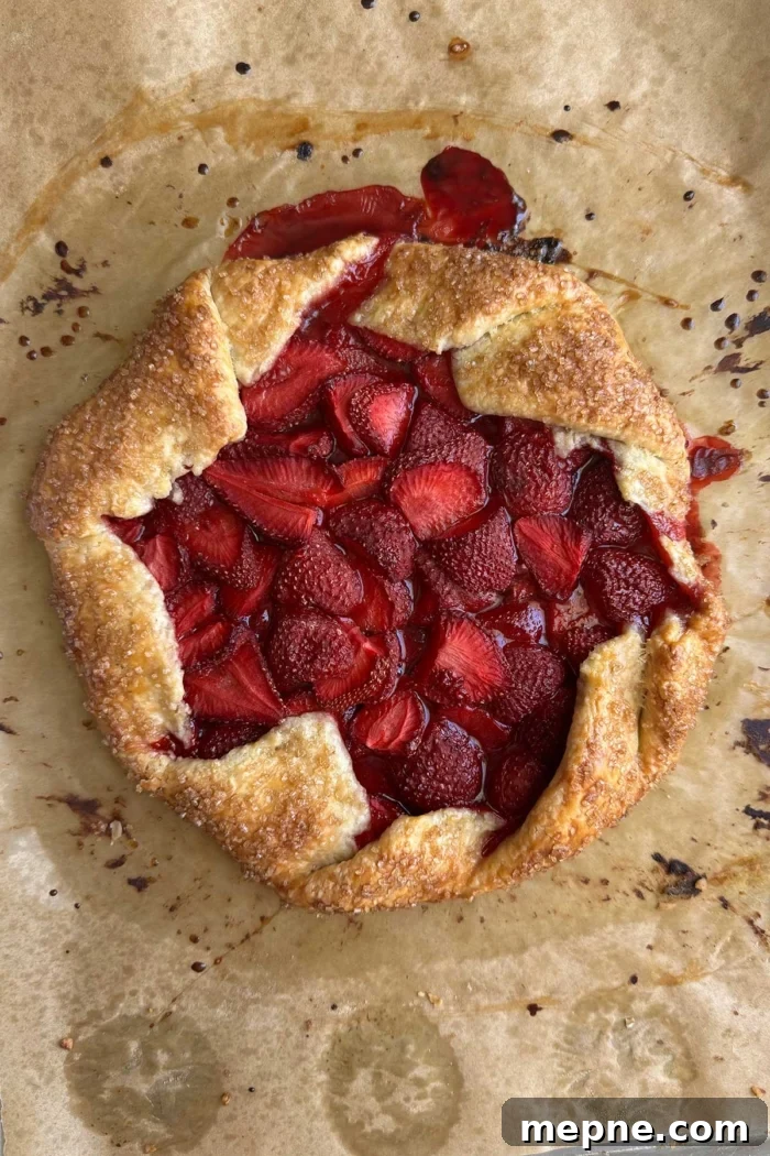 baked strawberry galette on parchment paper.