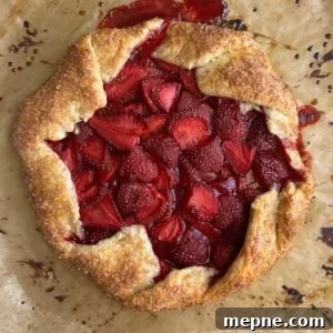 baked strawberry galette on parchment paper.