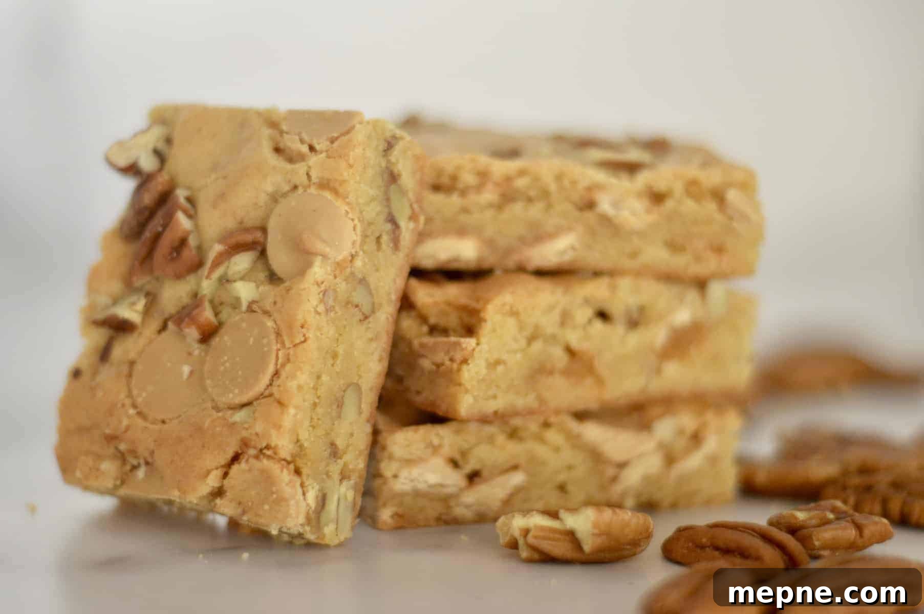 Gooey Caramel Chip Pecan Bars Recipe 4 bars on a marble counter