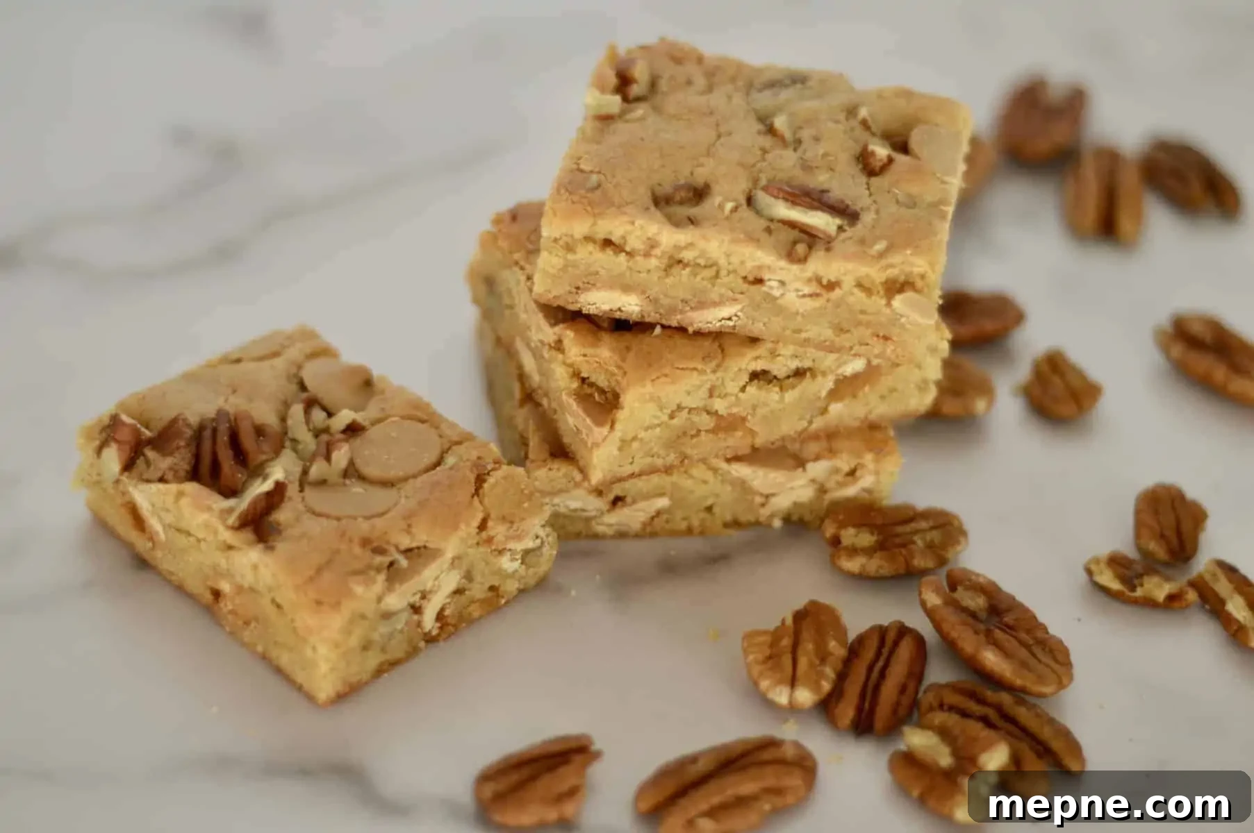 Gooey Caramel Chip Pecan Bars Recipe 6 Caramel Pecan Bars stacked on a countertop