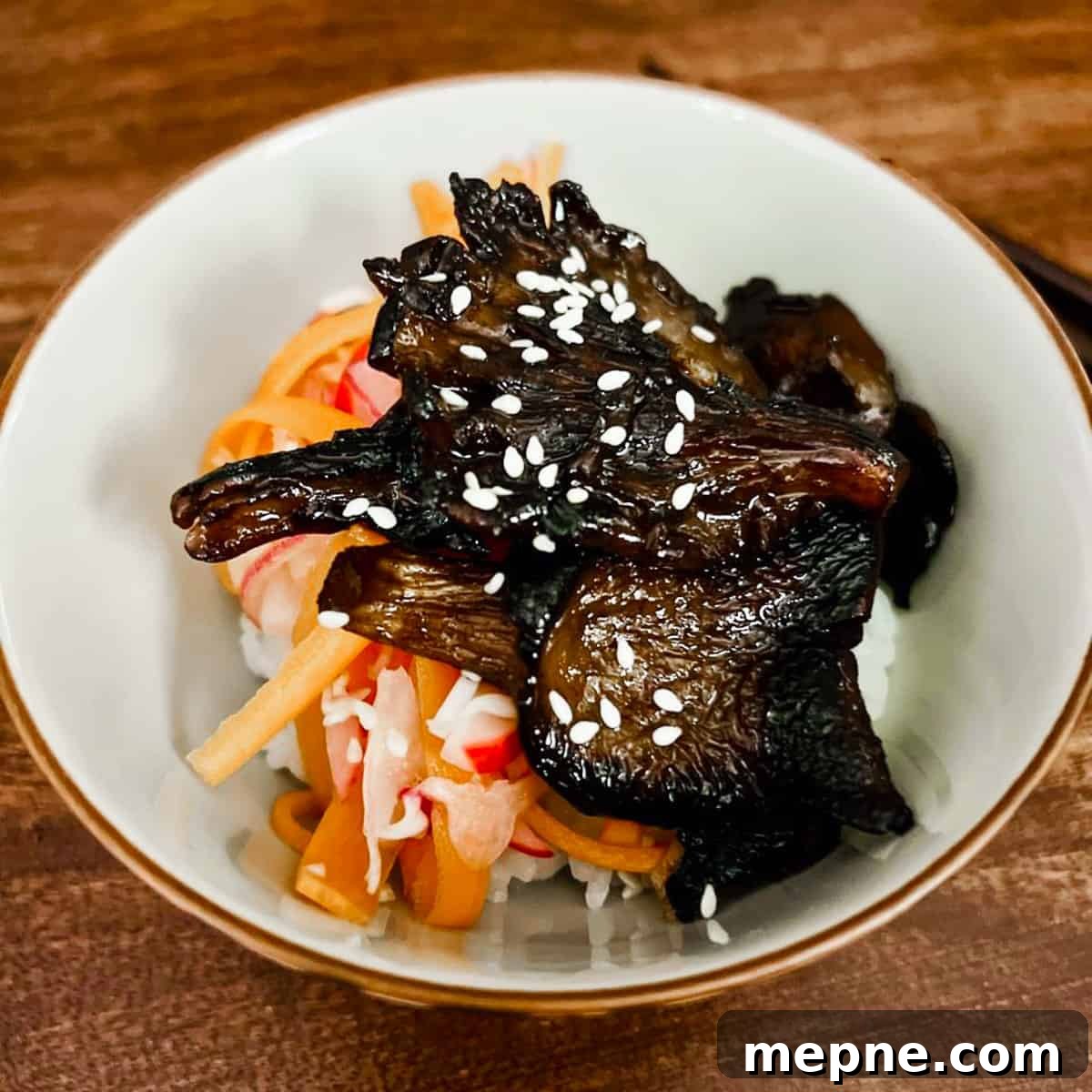 Crispy Chinese Fried Oyster Mushrooms with Vegan Char Siu Recipe 2 Photo of a small bowl filled with some sushi rice, pickled shredded vegetables and Char Siu mushrooms on top.