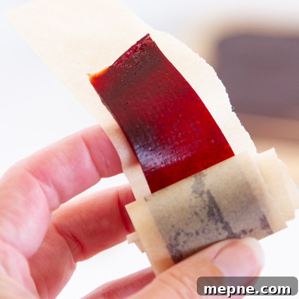 How to Make Strawberry Fruit Roll-Ups 5 unrolling the fruit leather while holding it in my hand