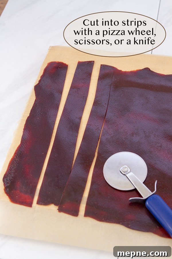 How to Make Strawberry Fruit Roll-Ups 9 cutting fruit leather with a pizza cutter