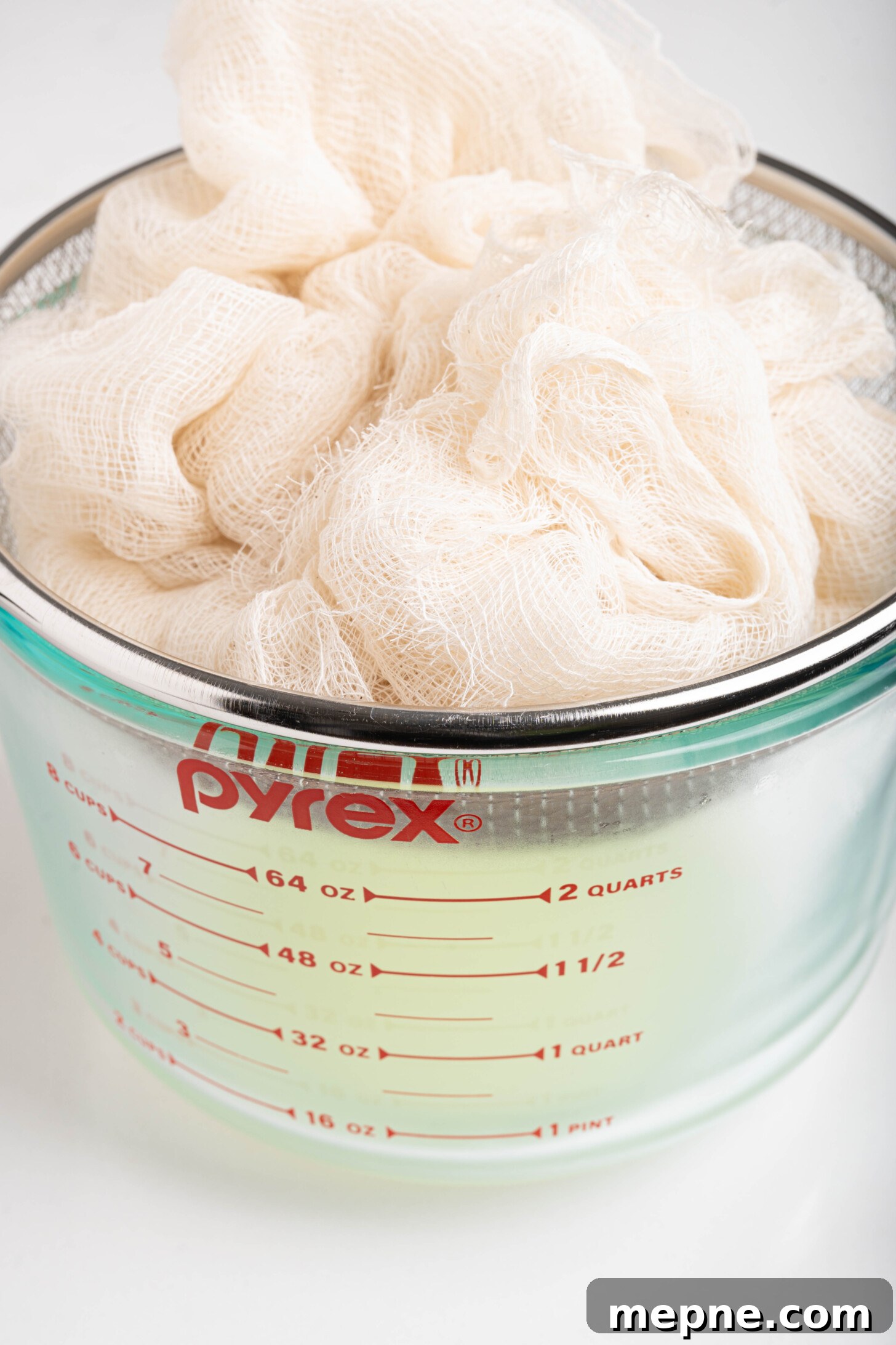 2 Ingredient Labneh Strained Yogurt Recipe 9 labneh in a strainer with cheesecloth