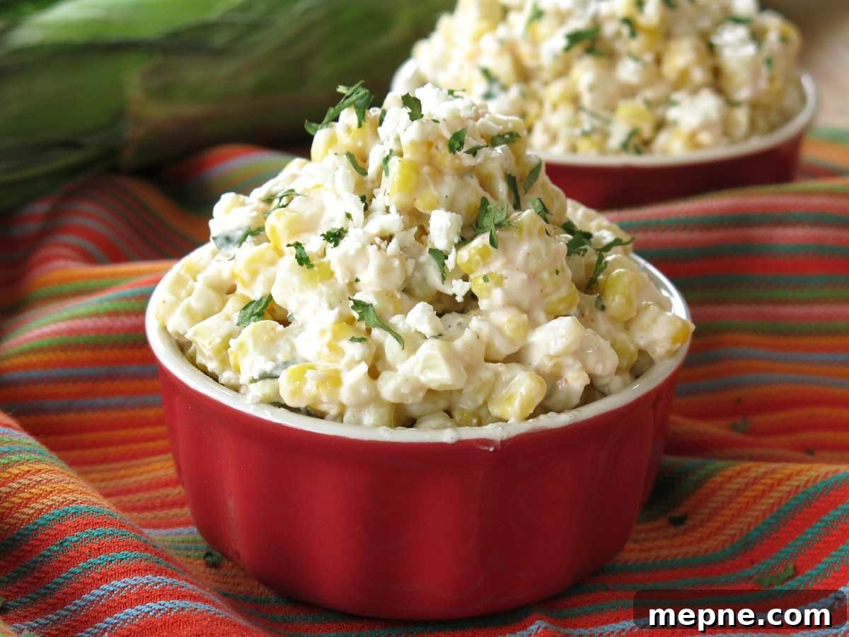 Over 15 Cinco de Mayo Dinner Recipes You'll Make Again 8 Mexican street corn in a red cup with another cup behind it with more elote.
